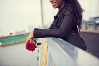 African American woman with red rose