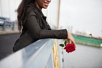 African American woman with red rose
