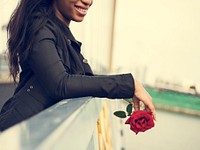 African American woman with red rose