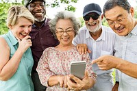 Group of happy retired seniors using a digital device