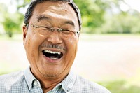 Closeup of a Japanese man smiling in a park