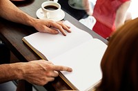 Hands pointing on blank book pages mockup