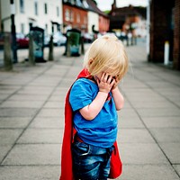 Little boy wearing superhero costume