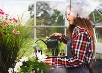 Young woman in the glass greenhouse