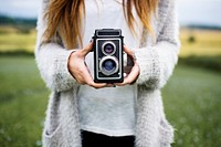 Woman holding retro film camera