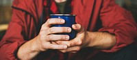 Closeup of hands holding coffee cup