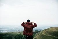 Rear view of man in hoodie jacket with nature landscape