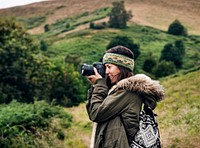 Woman with camera in the nature