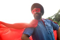 Senior Indian man playing superhero