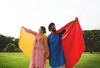 Loving senior Indian couple playing superheroes in the park