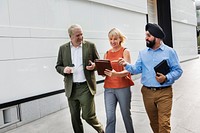 Business people walking and talking together in a city