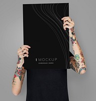 Tattooed woman showing blank mockup poster