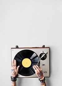 Tattooed woman playing a vinyl record