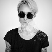 Tattooed woman with a smoke