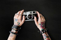 Tattooed woman with a vintage camera