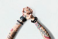 Tattooed hands clasped together