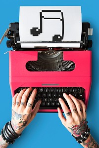 Tattooed woman typing on a typewriter