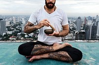 Man practicing yoga on the rooftop