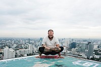 Man practicing yoga on the rooftop
