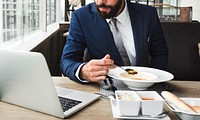 Businessman eating in a cafe