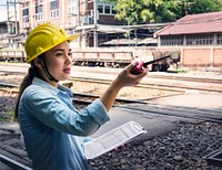 Female inspector at railroad tracks