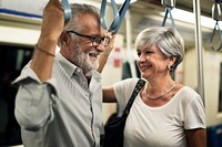 Senior couple traveling inside train subway