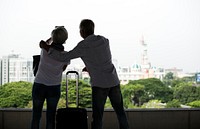 Senior couple traveling taking pictures