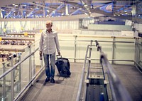Old grey haired guy walking around the airport
