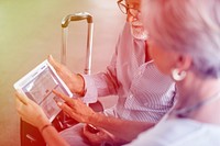 Senior adult couple checking boarding pass on digital tablet