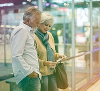 Senior adult couple with boarding pass at the airport