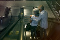 Lovely senior couple tourists on escalator