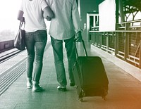 Senior adult couple with traveling luggage at train station