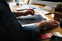 Fashion designer drawing, working in a studio