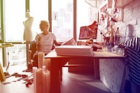 Fashion designer tattooed girl on her workspace