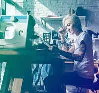 Fashion designer tattooed girl on her workspace