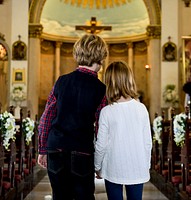 Children praying together inside a church