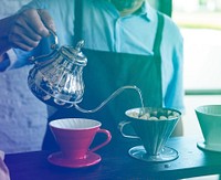 Senior adult man barista making coffee in cafe