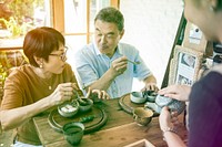 Waitress pouring tea for senior adult couple