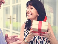 Woman holding a box of present with red bow