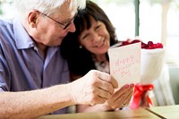 Man surprised his wife with a card and a bouquet of flowers