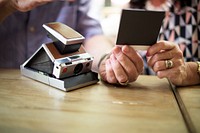 Close up couple checking instant camera image