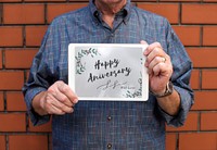 Guy holding a tablet happy anniversary
