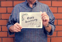 Guy holding a tablet happy anniversary