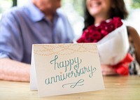 Happy Anniversary card with the couple in the background