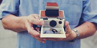 Guy holding a retro instant camera