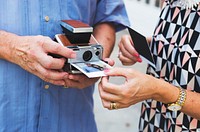 Couple printing a photo on instant camera
