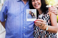 Couple showing a photo of themselves