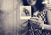 Close up couple showing instant camera image