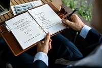 Businessman writing a business plan on a notebook