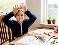 Little girl enjoying coloring paper